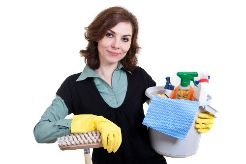 Professional carpet cleaner following safe work practices